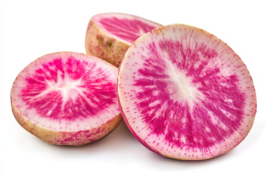 Three thick slices of watermelon radish display striking pink and white concentric patterns. The vibrant colors stand out against a clean, bright background.