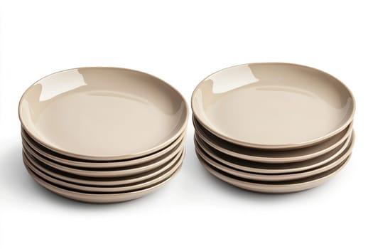 A set of nine ceramic plates, varying in size, are stacked in two neat groups on a white surface, reflecting a modern and minimalistic dining style ideal for everyday use.