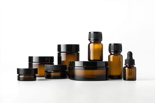 A collection of amber glass containers in different shapes and sizes is neatly arranged on a white surface, showcasing skincare and wellness products.
