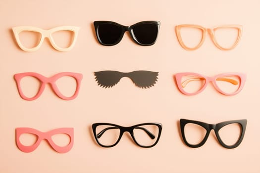 A collection of nine pairs of trendy sunglasses in various colors and shapes is showcased against a soft pastel backdrop, creating an eye-catching display.