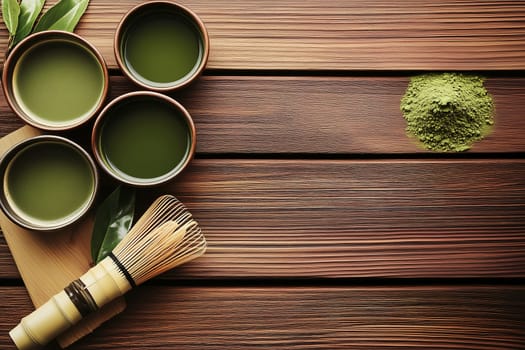 Four bowls filled with green tea sit on a rustic wooden table alongside vibrant matcha powder, a bamboo whisk, and fresh tea leaves, creating a calming atmosphere for tea preparation.