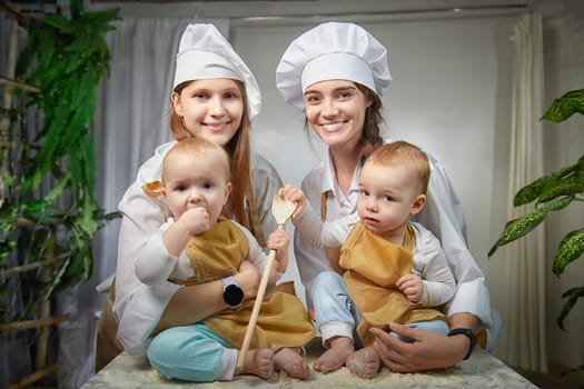A families enjoys a fun cooking session, playfully covered in flour while engaging with little ones in warm kitchen. Mothers and children having fun