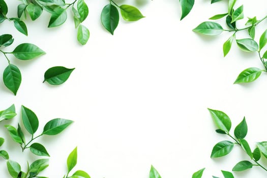 Vibrant green leaves are meticulously arranged in a circular formation on a smooth white surface, perfect for crafting invitations or nature-themed designs.