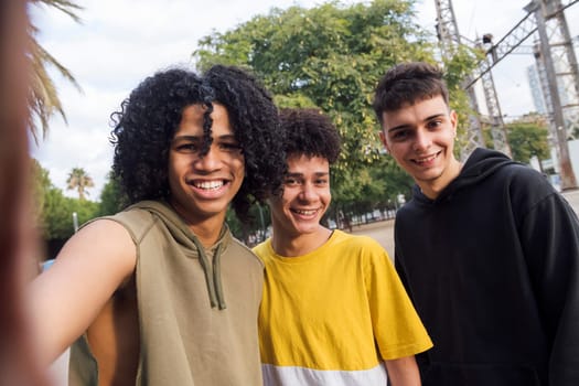 selfie photo of three multiethnic teenagers laughing happy looking at camera, concept of youth lifestyle and technology of communication