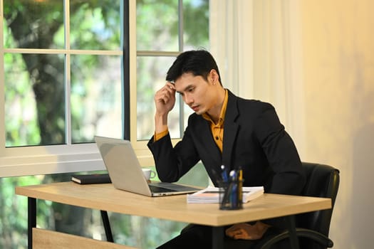 Serious businessman contemplating solutions to business problems.
