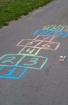 Children jumping hopscotch on the street. Selective focus. kids.