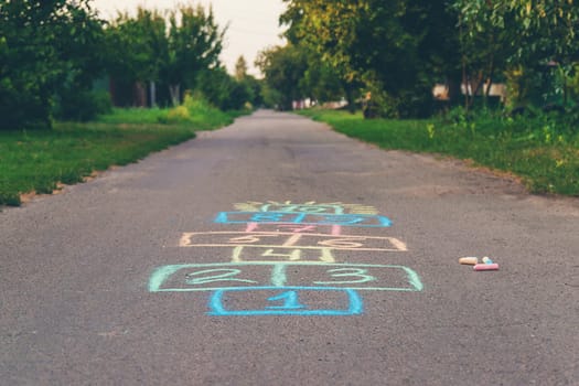 Children jumping hopscotch on the street. Selective focus. kids.