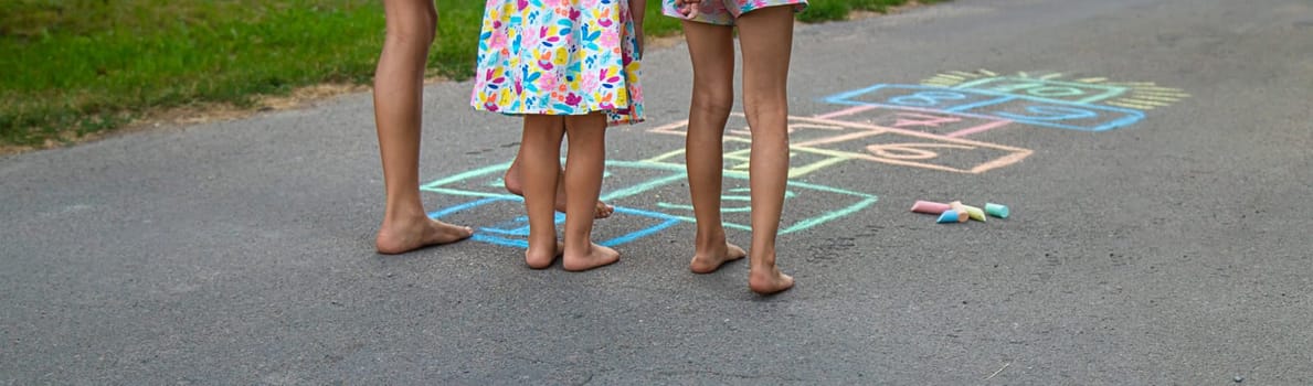 Children jumping hopscotch on the street. Selective focus. kids.