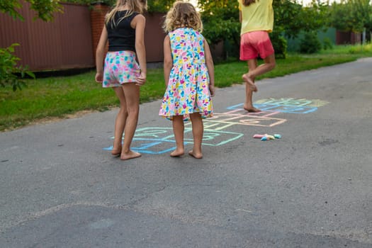 Children jumping hopscotch on the street. Selective focus. kids.
