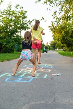 Children jumping hopscotch on the street. Selective focus. kids.