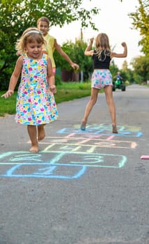 Children jumping hopscotch on the street. Selective focus. kids.