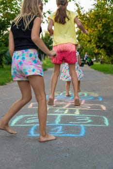 Children jumping hopscotch on the street. Selective focus. kids.
