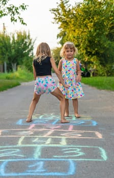 Children jumping hopscotch on the street. Selective focus. kids.