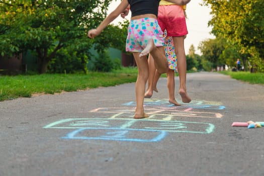 Children jumping hopscotch on the street. Selective focus. kids.