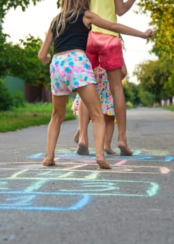 Children jumping hopscotch on the street. Selective focus. kids.