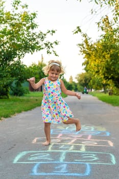 Children jumping hopscotch on the street. Selective focus. kids.