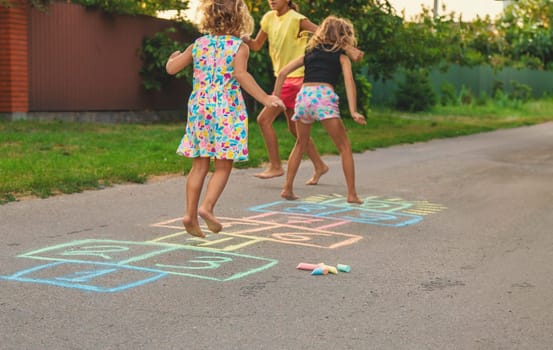 Children jumping hopscotch on the street. Selective focus. kids.
