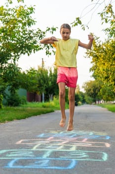 Children jumping hopscotch on the street. Selective focus. kids.