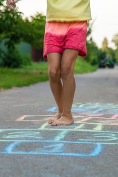 Children jumping hopscotch on the street. Selective focus. kids.
