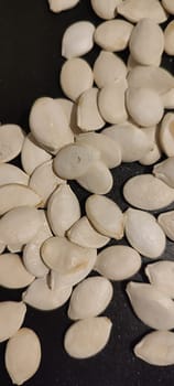 white pumpkin seeds healthy food in black pan. High quality photo