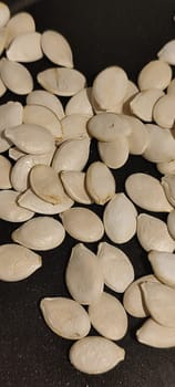 white pumpkin seeds healthy food in black pan. High quality photo