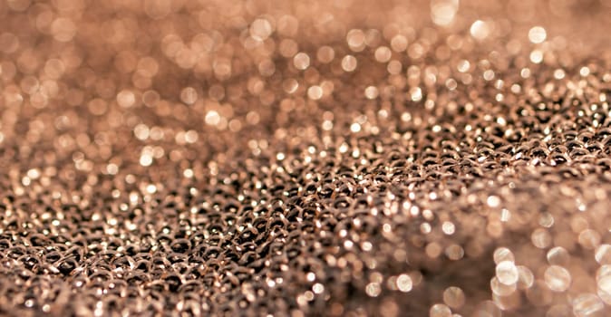 Horizontal blurred golden bronze surface. Shiny material background. Pure gold wire mesh. Chrome bronze Fabric waves. 