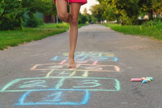 Children jumping hopscotch on the street. Selective focus. kids.
