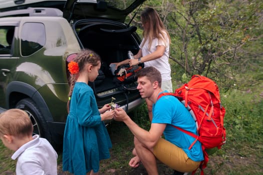A happy family prepares for an exciting hike in the beautiful great outdoors, cherishing quality time together