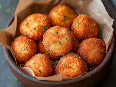 A close-up of deliciously crispy golden potato croquettes served in a rustic wooden bowl. Perfectly garnished with fresh herbs, these croquettes are ideal for appetizers or party snacks.