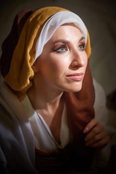 A girl dressed in stylized national clothing evokes the character Rebekah, captured in soft lighting with an expressive gaze.