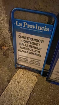 Cremona, Lombardy, Italy October 15th 2024 Newsstand displaying la provincia newspaper headline about four new dengue cases in cremona and crema, italy, raising concern