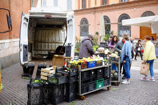Cremona, Lombardy, Italy - November 6th 2024 Farmers selling vegetables from their delivery van at a local farmers market