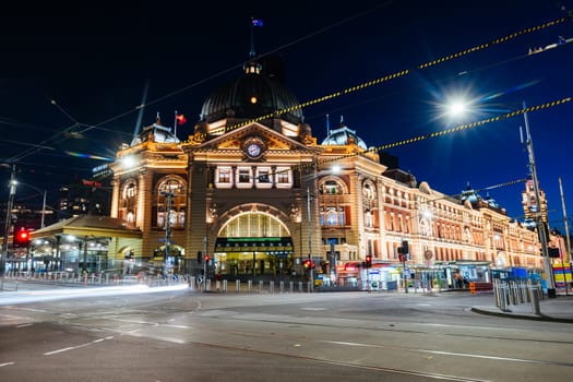 MELBOURNE, AUSTRALIA - OCTOBER 10, 2024: Melbourne's Flinders Station at dusk and rush hour with traffic and pedestrians on October 10th, 2024