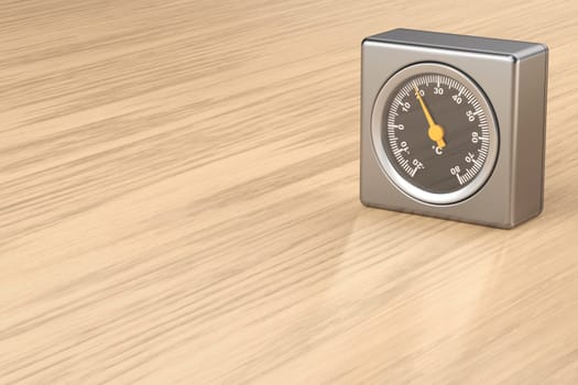 Silver room thermometer on shiny wooden desk