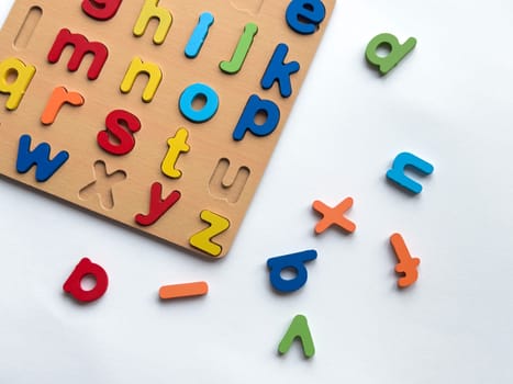 Colorful wooden alphabet puzzle board for early education and fun learning.