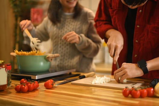 Young couple preparing a special holiday dinner together with fresh ingredients.