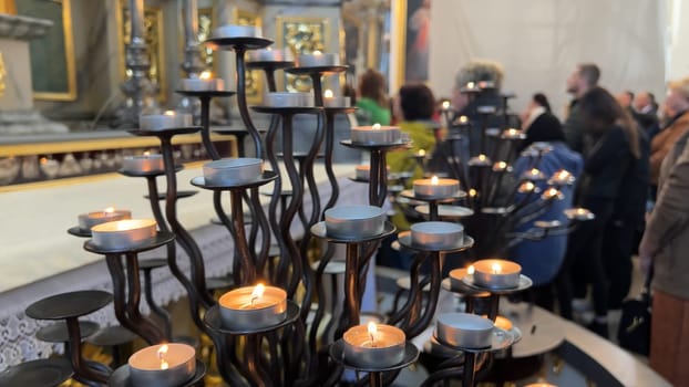 Burning candles in a Catholic church during the Divine Service