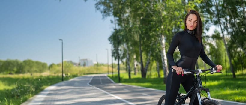 Caucasian woman riding a bike in a park