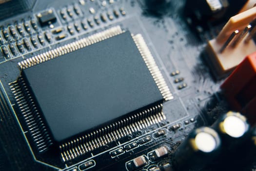 A detailed view of a microchip on a circuit board, showcasing various electronic components skillfully