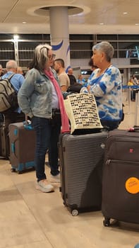 15 October 2024 Tel-Aviv Israel Ben Gurion airport Terminal 3, tourist lounge, flag Israeli, people womens travel tourists waiting.High quality photo