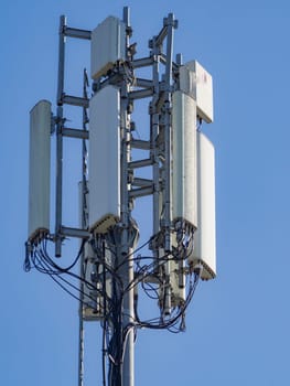 Telecommunication tower stands tall against a clear blue sky, broadcasting signals for mobile communication and internet connectivity, ensuring seamless communication in the modern world