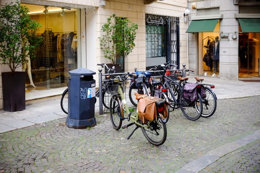 Cremona, Lombardy, Italy - November 7th 2024 Bicycles parked near storefronts creating a charming urban scene