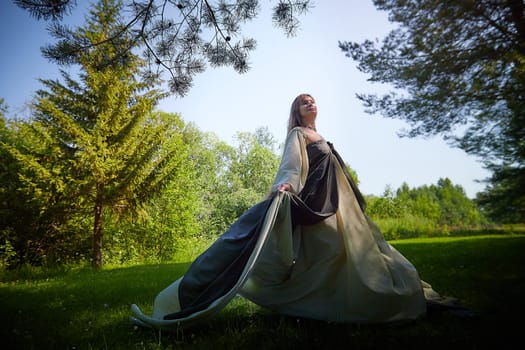 Beautiful dryad or fairy in nature. Pagan spirit of forest. Environmental friendliness, caring for nature. Adult mature woman 40-60 in Photo shoot