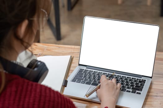 Image of female hand using and touching on laptop touchpad with blank white desktop screen..