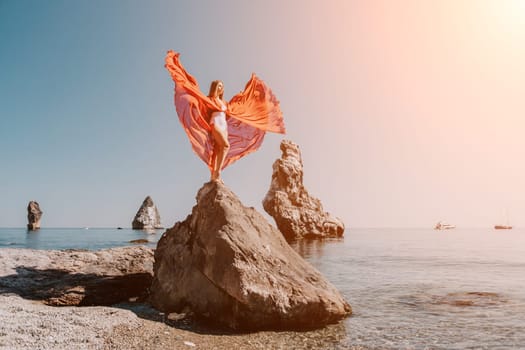 Woman travel sea. Happy tourist taking picture outdoors for memories. Woman traveler looks at the edge of the cliff on the sea bay of mountains, sharing travel adventure journey.