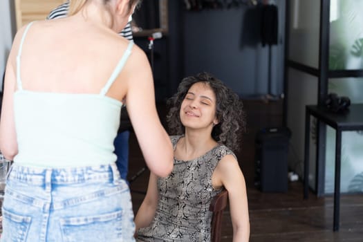 young beautiful woman doing makeup for woman