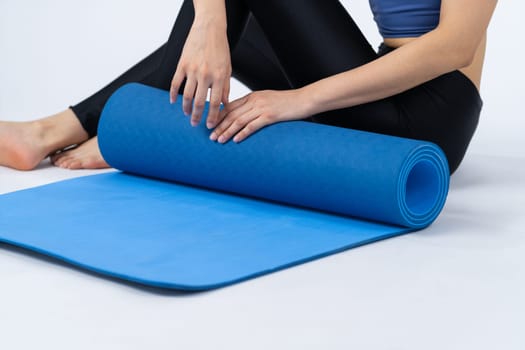 Young attractive asian woman portrait in sportswear with exercising mat. Healthy exercise and workout routine lifestyle concept. Studio shot isolated background. Vigorous