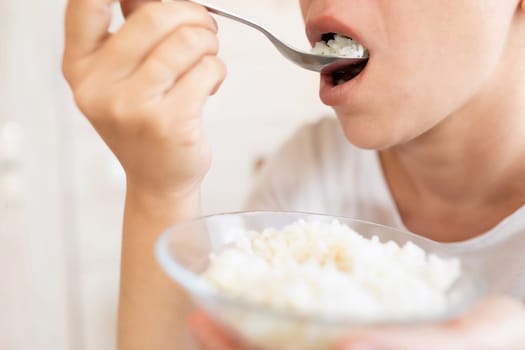 the woman is hungry and therefore eats rice with spoons.