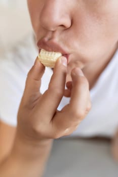 woman has a craving for sweet food and eats waffles.