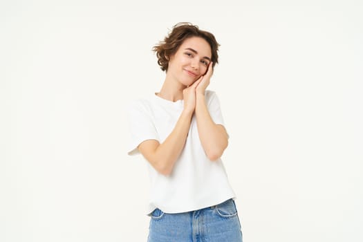 Portrait of cute, silly young woman, look with admiration, gazing at something, standing over white background.